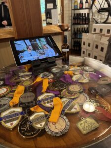 A bunch of awards under glass on a table at Eleven Winery.